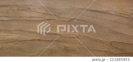 Shimmering Gold Sand Texture with Subtle Layered Patterns and Glittering Highlights 121885953