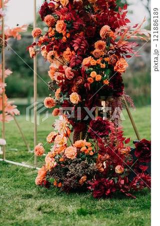 A bunch of vibrant flowers sits atop a lush green field 121886189