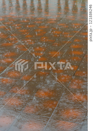 A close up view of a very wet tiled floor during the rainfall 121886246