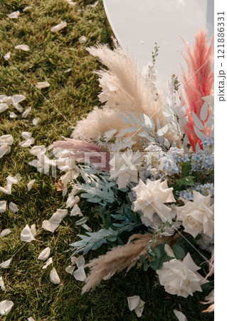 An arrangement of colorful flowers can be seen laying gently on the grass 121886331