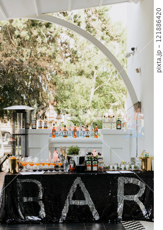 A bar with a black sequined tablecloth and the word bar on it A bar with a black sequined tablecloth and the word bar on it 121886420