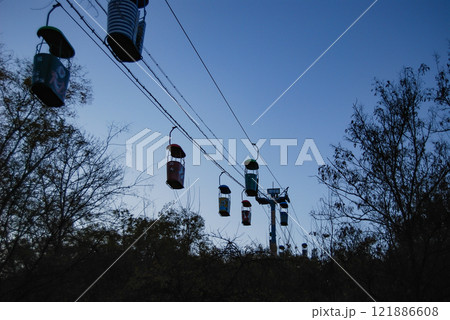 Odessa cable car. Against the backdrop of a blue sky are the cabins of the cable car that connects the French Boulevard with Otrada Beach. Odessa cable car. Against the backdrop of a blue sky are the cabins of the cable car that connects the French Boulevard with Otrada Beach. 121886608