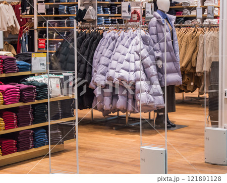 interior of fashion boutiques with modern clothing and mannequins 121891128