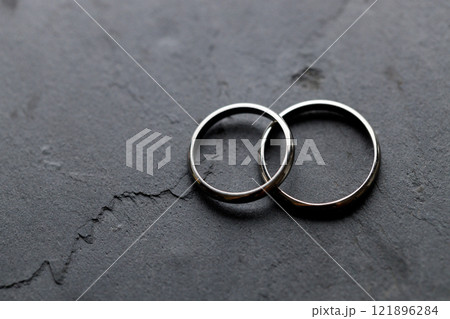 White gold rings on rustic black background. White gold rings on rustic black background. 121896284
