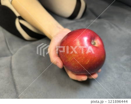 red apple held by human hands red apple held by human hands 121896444