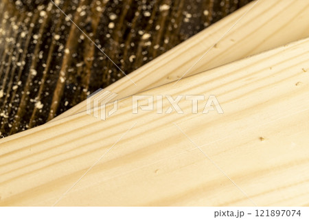 metal drill bit and pine wood board during operation metal drill bit and pine wood board during operation 121897074