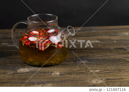 red rosehip fruits on a black tea table red rosehip fruits on a black tea table 121897116