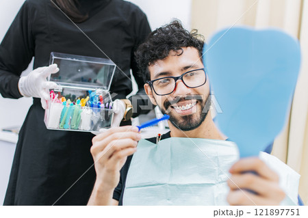 Dentist with patient choosing metal braces, Patient with dentist choosing rubber band, Patient with dentist choosing dental braces Dentist with patient choosing metal braces, Patient with dentist choosing rubber band, Patient with dentist choosing dental braces 121897751