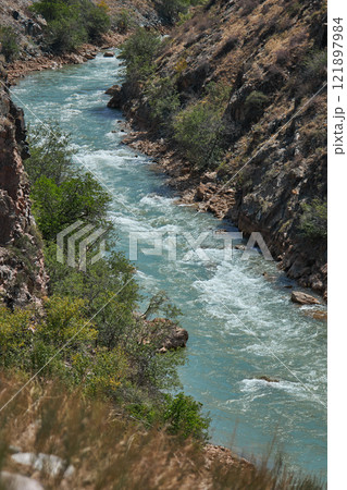A Serene River Elegantly Flowing Through a Stunning Rocky Canyon Landscape 121897984