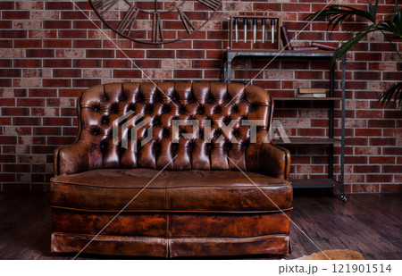 Old leather sofa. Brown furniture. Retro bed with a soft back. Old leather sofa. Brown furniture. Retro bed with a soft back. 121901514