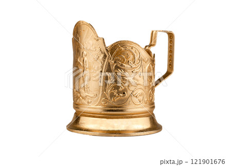 Cup holder isolated on a white background. Old gold-colored metal cup holder. Cup holder isolated on a white background. Old gold-colored metal cup holder. 121901676
