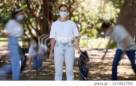 Volunteers, hygiene and environmental team cleaning a park in covid masks together. Development, energy and recycling activists working in collaboration to put messy dirt in plastic bags and trash Volunteers, hygiene and environmental team cleaning a park in covid masks together. Development, energy and recycling activists working in collaboration to put messy dirt in plastic bags and trash 121901760