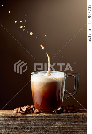 Coffee and chocolate drink with cream on a brown background. Coffee and chocolate drink with cream on a brown background. 121902735