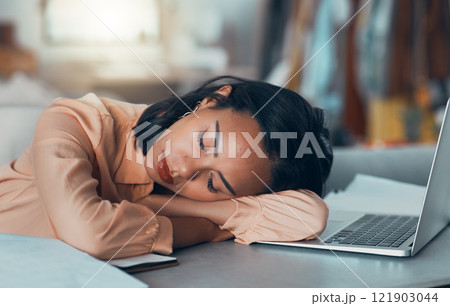 Tired woman suffering from burnout at work, sleeping at desk and napping after meeting a deadline in an office alone. Business woman and corporate professional resting, taking a break with laptop 121903044