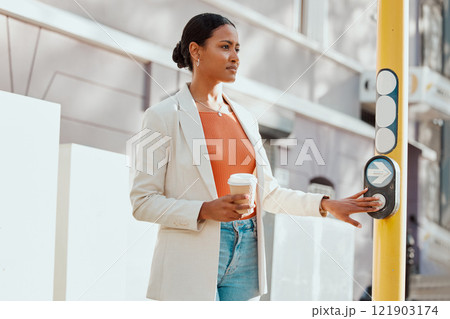 Crossing street, crosswalk or road at a pedestrian traffic light signal while waiting in a city outdoors. Young woman pressing button while traveling, commuting and walking in town on her way to work 121903174