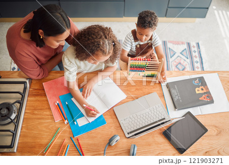 Learning, education and family doing homework with girl child writing in her book during homeschooling lesson with her mother from above. Student, development and studying during quarantine at home 121903271