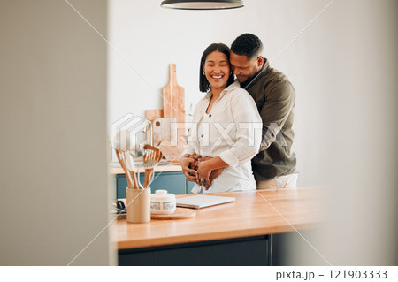 Hugging, happy and excited couple spending quality time together and relaxing at home. Loving, relaxed and affectionate African lovers embracing, cuddling and having fun in the house 121903333