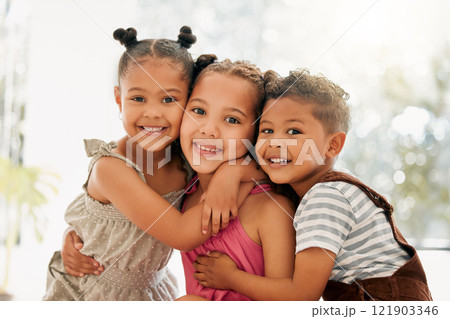 Siblings, boy and girl children hugging and bonding together as a cute happy family indoors during summer. Portrait of young, brother and sister kids smiling, embracing and enjoying their childhood 121903346