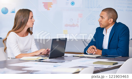Collaboration, teamwork and planning team of social media marketing and advertising professionals talking in strategy meeting. A man and woman working on a messy office, workstation or workplace desk 121903463
