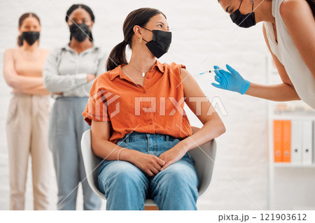 Vaccine, injection and medicine treatment for covid, flu and pandemic disease with nurse, healthcare or medical professional. Stylish, edgy and creative office woman with mask getting injected in arm 121903612