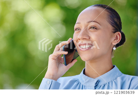 Woman calling, smiling and talking on a phone call while standing outside against green copy space. Happy, positive and ambitious woman with a positive mindset getting good news about insurance offer 121903639