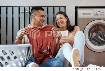Carefree and funny couple doing laundry and relaxing together at home in the morning. Silly, goofy and playful lovers laughing and giggling while cleaning the washing, and doing house chores Carefree and funny couple doing laundry and relaxing together at home in the morning. Silly, goofy and playful lovers laughing and giggling while cleaning the washing, and doing house chores 121903786