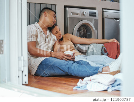 Couple, chores and laundry while doing home cleaning wile feeling tired and relaxing together. Loving boyfriend and girlfriend with a healthy relationship while sitting together on wash day Couple, chores and laundry while doing home cleaning wile feeling tired and relaxing together. Loving boyfriend and girlfriend with a healthy relationship while sitting together on wash day 121903787