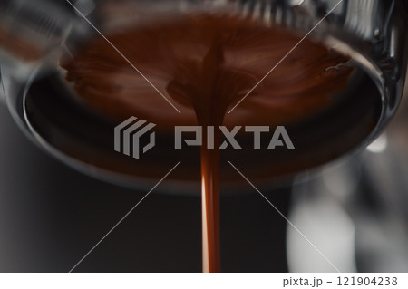 Extracting espresso with naked portafilter closeup 121904238