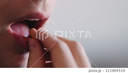 man takes pill closeup shallwo focus man takes pill closeup shallwo focus 121904319