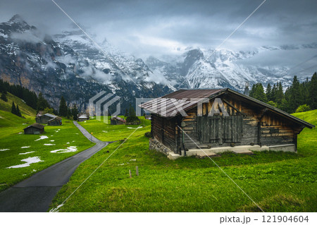 Wooden huts and misty snowy mountains in Switzerland 121904604