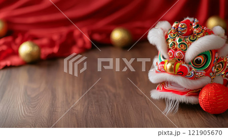 Colorful lion dance headpiece on wooden floor with festive decorations. for Chinese New Year 121905670