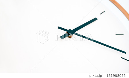 Minimalist Clock Design with Black Hands on a White Background, Highlighting Elegance and Simplicity 121908033