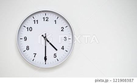 Minimalist White Clock with Silver Frame Striking 16.30/04.30 on White Background. Perfect for Time Management and Corporate Campaigns Minimalist White Clock with Silver Frame Striking 16.30/04.30 on White Background. Perfect for Time Management and Corporate Campaigns 121908387