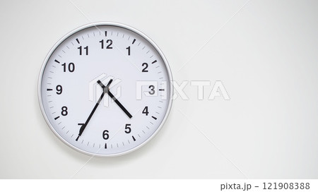 Minimalist White Clock with Silver Frame Striking 16.35/04.35 on White Background. Perfect for Time Management and Corporate Campaigns Minimalist White Clock with Silver Frame Striking 16.35/04.35 on White Background. Perfect for Time Management and Corporate Campaigns 121908388