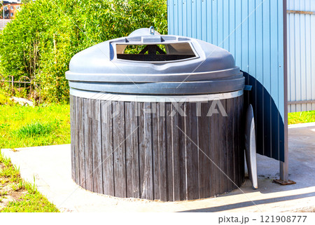 Big round garbage container for household waste at the city Big round garbage container for household waste at the city 121908777