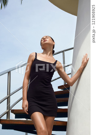 Beautiful body woman on stairs of Lighthouse. Sexy girl in short dress Beautiful body woman on stairs of Lighthouse. Sexy girl in short dress 121908925