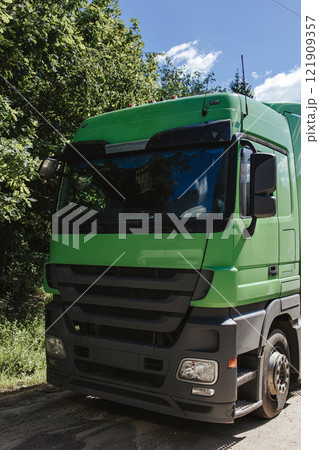 Vertical photo of a truck cabin. Green truck cabin. Cargo transportation. 121909357