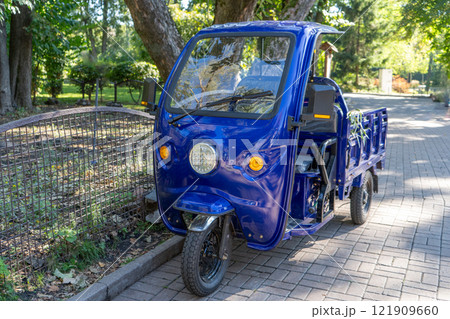Three wheels motorcycle with cabin. Blue car with trailer for one 121909660