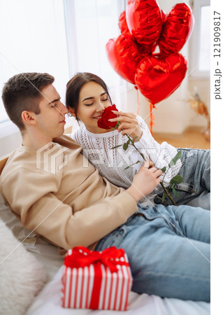 Exchange of gifts. Romantic day together. Valentines day, couple, relationships and people concept. Exchange of gifts. Romantic day together. Valentines day, couple, relationships and people concept. 121909817