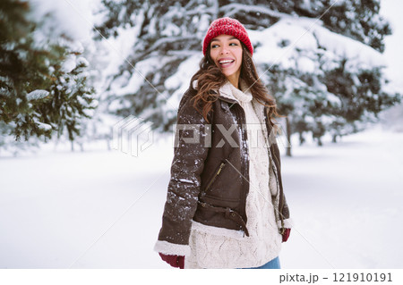 young woman plays with a snow in sunny winter day. Christmas, holidays concept. 121910191