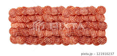 Salami chips isolated, wavy sausage slices, sliced dry chorizo, sausages thin pieces, pepperoni pizza ingredient 121910237