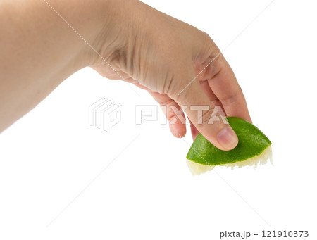 Squeezed lime isolated, squeezed out half green lemon on white background, burnout symbol 121910373