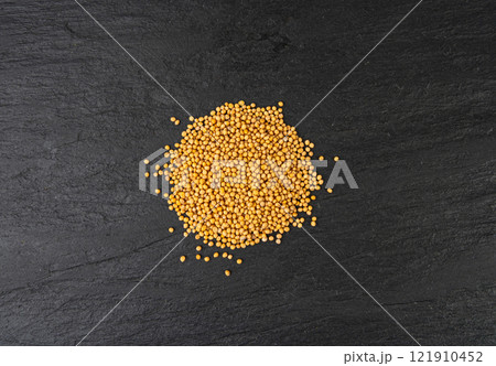 Mustard seeds isolated, dry yellow sinapis alba grains, mostarde balls on white background 121910452