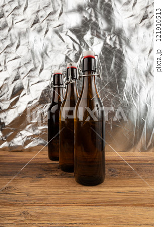 Old beer bottle, brown glass vintage beerbottle, a quality traditional time-tested drink symbol Old beer bottle, brown glass vintage beerbottle, a quality traditional time-tested drink symbol 121910513