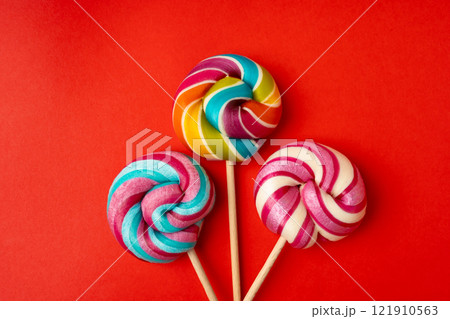 Color lollipop, spiral candy on stick, colorful striped lollypop, round fruit caramel, circle lollipop 121910563