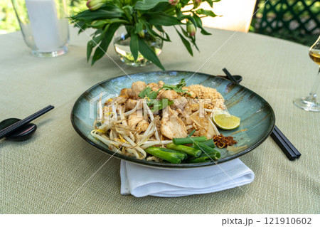 Pad thai, phat thai, or phad tha asian noodles, chinese rice pasta with meat in thailand restaurant table 121910602