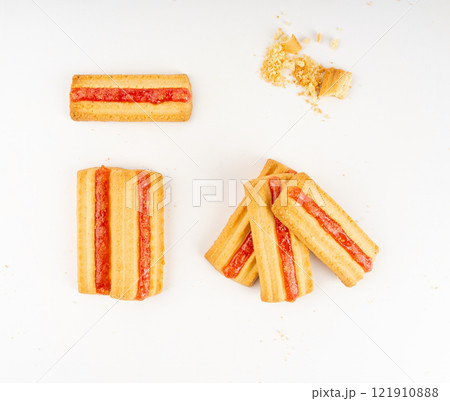 Shortbread sticks with a jam strip isolated, biscuit cookies with fruit marmalade or jelly on white 121910888