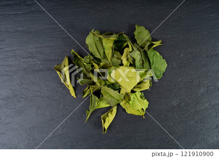 Thai lime dried leaves, makrut lime or Citrus hystrix leaf pile, kaffir lime dry sprouts, Southeast Asia spices 121910900