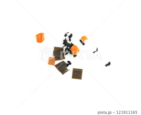 Dry kelp seaweed squares, mini wakame pieces isolated, dried kombu and carrot flakes from ramen 121911165