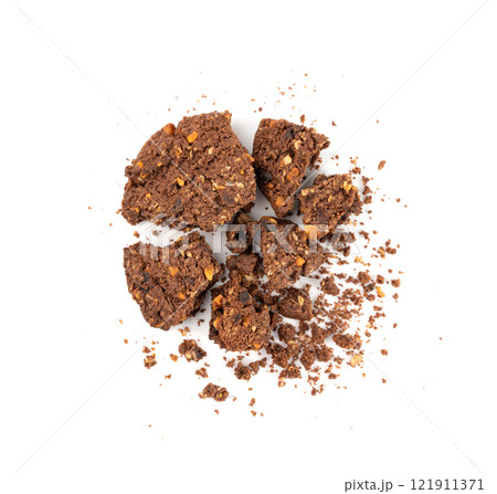 Crumbled chocolate oatmeal cookies isolated, broken cereal oat crackers with nuts Crumbled chocolate oatmeal cookies isolated, broken cereal oat crackers with nuts 121911371